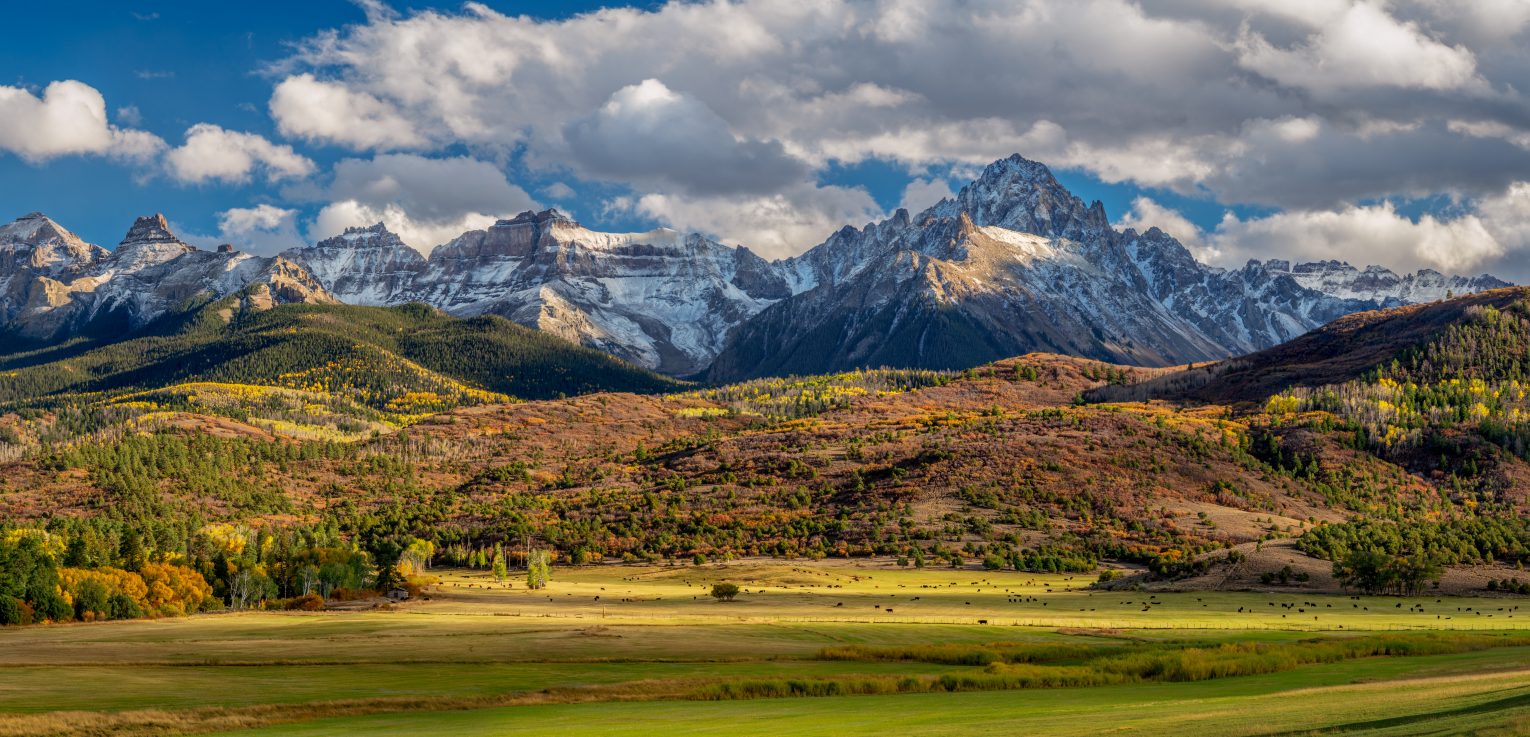 Colorado Mountain Scenery with clouds and a field